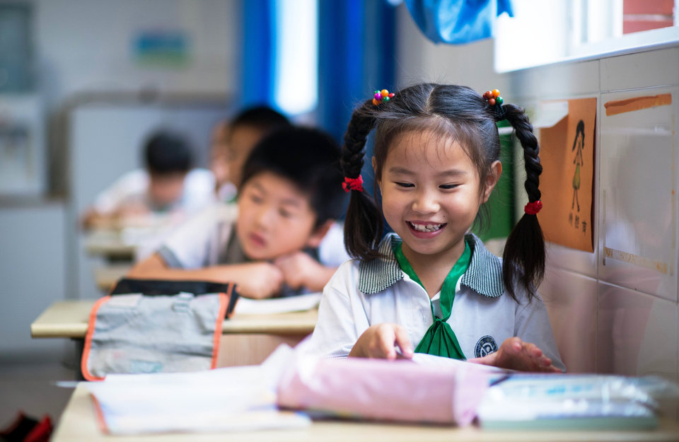 Chinese childen attend a Chinese class at the Jinqao Center Primary School in Shanghai on September 1, 2014. The Shanghai Education Commission recently announced the opening of 50 new public schools in the city, according to local news. AFP PHOTO / JOHANNES EISELE (Photo credit should read JOHANNES EISELE/AFP/Getty Images)