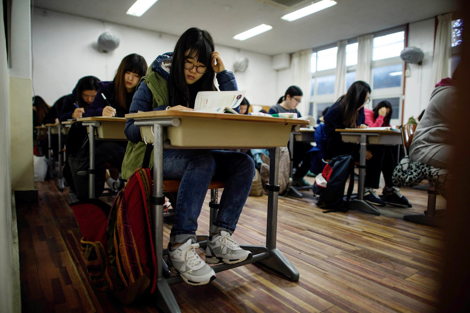 Students sit the annual Scolastic Aptitude Test at a the Poongmun high school in Seoul on November 13, 2014. South Korea went into "hush" mode, as nearly 650,000 students sat the annual college entrance exam that will play a large part in defining their adult lives in an ultra-competitive society. AFP PHOTO / Ed Jones (Photo credit should read ED JONES/AFP/Getty Images)