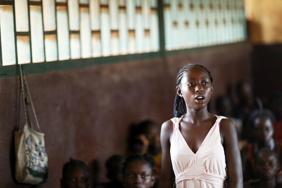 BANGUI, CENTRAL AFRICAN REPUBLIC - MARCH 12: A student standing and the rest of the students sitting in a classroom at a school the capital city of Bangui, Central African Republic as seen on March 12, 2014. (Photo by Thomas Koehler/Photothek via Getty Images)