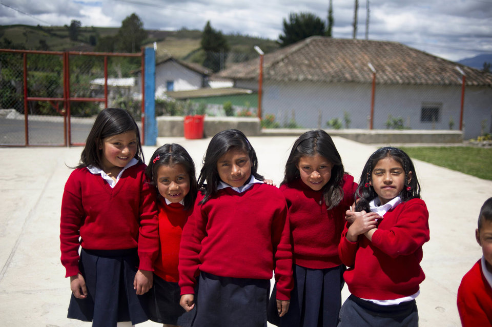 Girls pose at a rural school at La Palizada in Tulcan, Carchi province, in Ecuador close to the Colombian border on November 7, 2012. AFP PHOTO/Eitan Abramovich (Photo credit should read EITAN ABRAMOVICH/AFP/Getty Images)