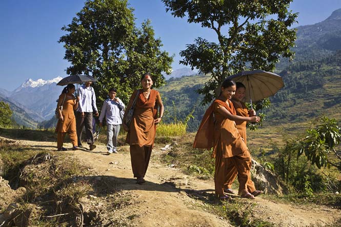 School Girls In Orange Uniforms Walk To School Along A Trail, Around Manaslu Trek, Nepal . (Photo By: Education Images/UIG via Getty Images)