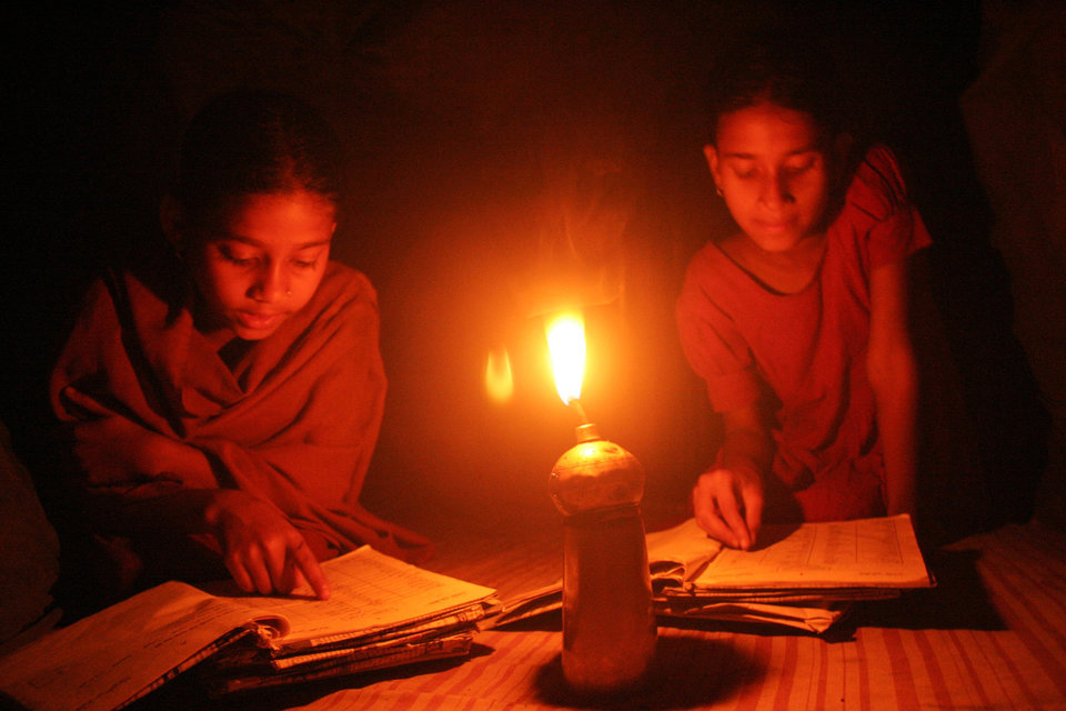 Children learning their lessons at home, in a village, in Netrokona, Bangladesh. February 15, 2009. (Photo by: Majority World/UIG via Getty Images)