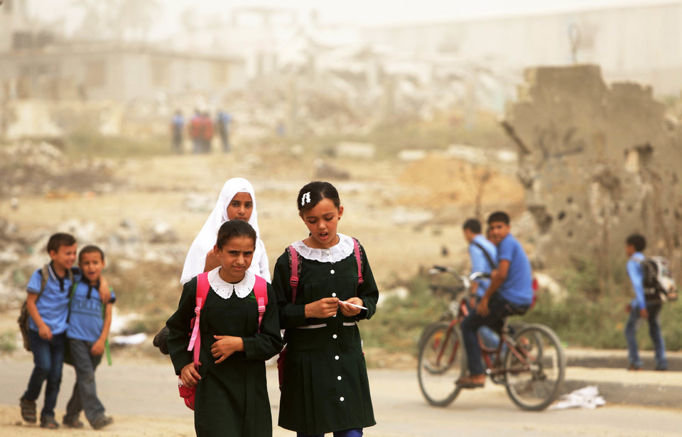 Palestinian school girls walk during a sandstorm in Gaza City on September 9, 2015. A dense sandstorm engulfing parts of the Middle East left at least eight people dead and hundreds suffering from respiratory problems, as officials warned residents to stay indoors. AFP PHOTO / MAHMUD HAMS (Photo credit should read MAHMUD HAMS/AFP/Getty Images)