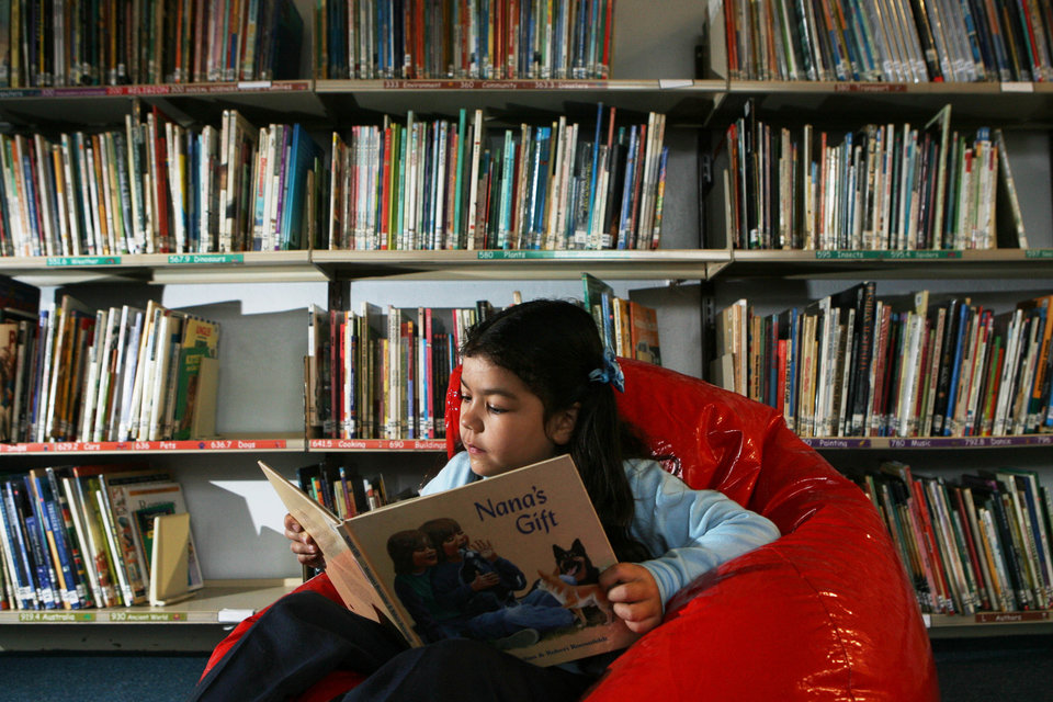 (AUSTRALIA & NEW ZEALAND OUT) Raeychale Cloutman, 6, from Malabar Public School, reads on a beanbag at her school, 19 July 2006. SHD Picture by ANTHONY JOHNSON (Photo by Fairfax Media via Getty Images)