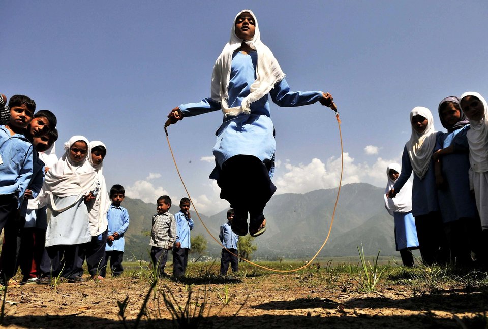 SRINAGAR, INDIA - AUGUST 11: Kashmiri school girls playing during recess in Kulhama district, Bandipora on August 11, 2015 in Srinagar, India. (Photo by Waseem Andrabi/Hindustan Times via Getty Images)