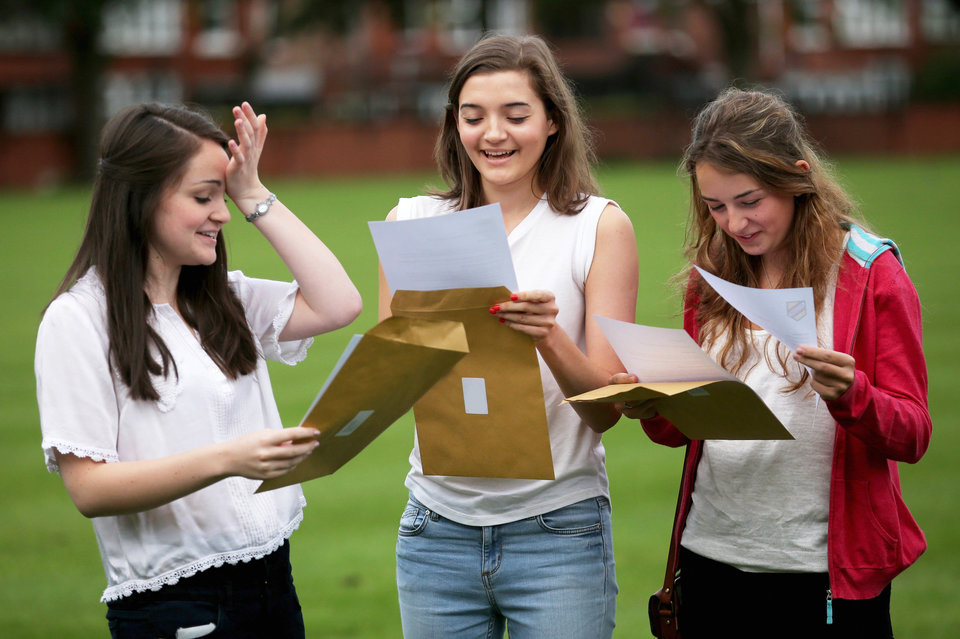 MANCHESTER, ENGLAND - AUGUST 15: (EDITORS NOTE: This image has been manipulated to remove personal details) Withington Independent Girls School pupils Helen Carrington (L), 18, Eliza Rooney, 17 and Rebecca Gray (R), 18, celebrate achieving four A* each in their A level exams on August 15, 2013 in Manchester, England. Over 300,000 teenagers are getting the results of their A-levels today as university admissions body UCAS said a record number of students have been accepted by UK universities. (Photo by Christopher Furlong/Getty Images)